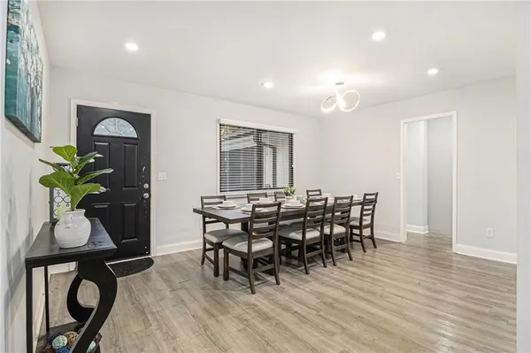 a view of a dining room with furniture and wooden floor
