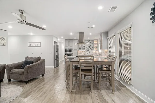 a dining room with furniture and wooden floor