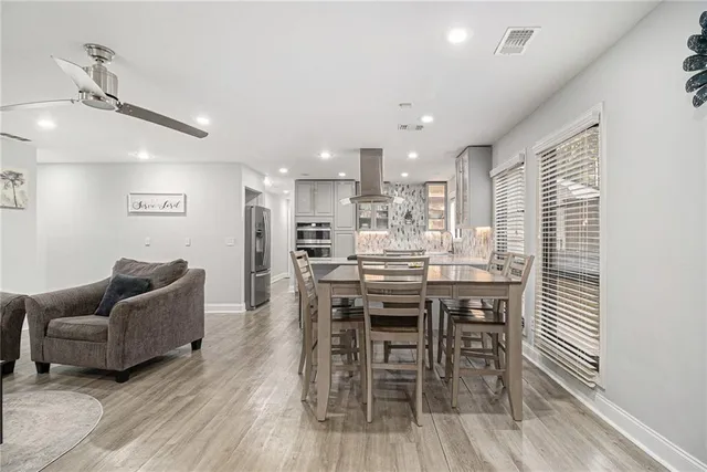 a dining room with furniture and wooden floor