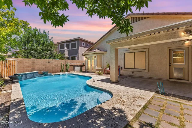 a view of a house with backyard and sitting area