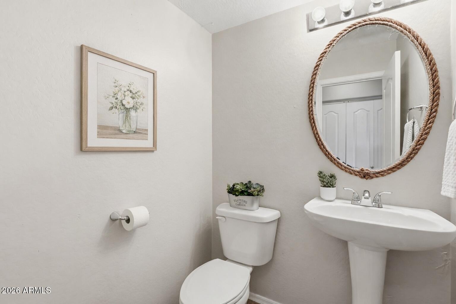 1853 South Balboa Drive Gilbert, AZ 85295 - Photo 15 of 32 a bathroom with a toilet a sink and a mirror