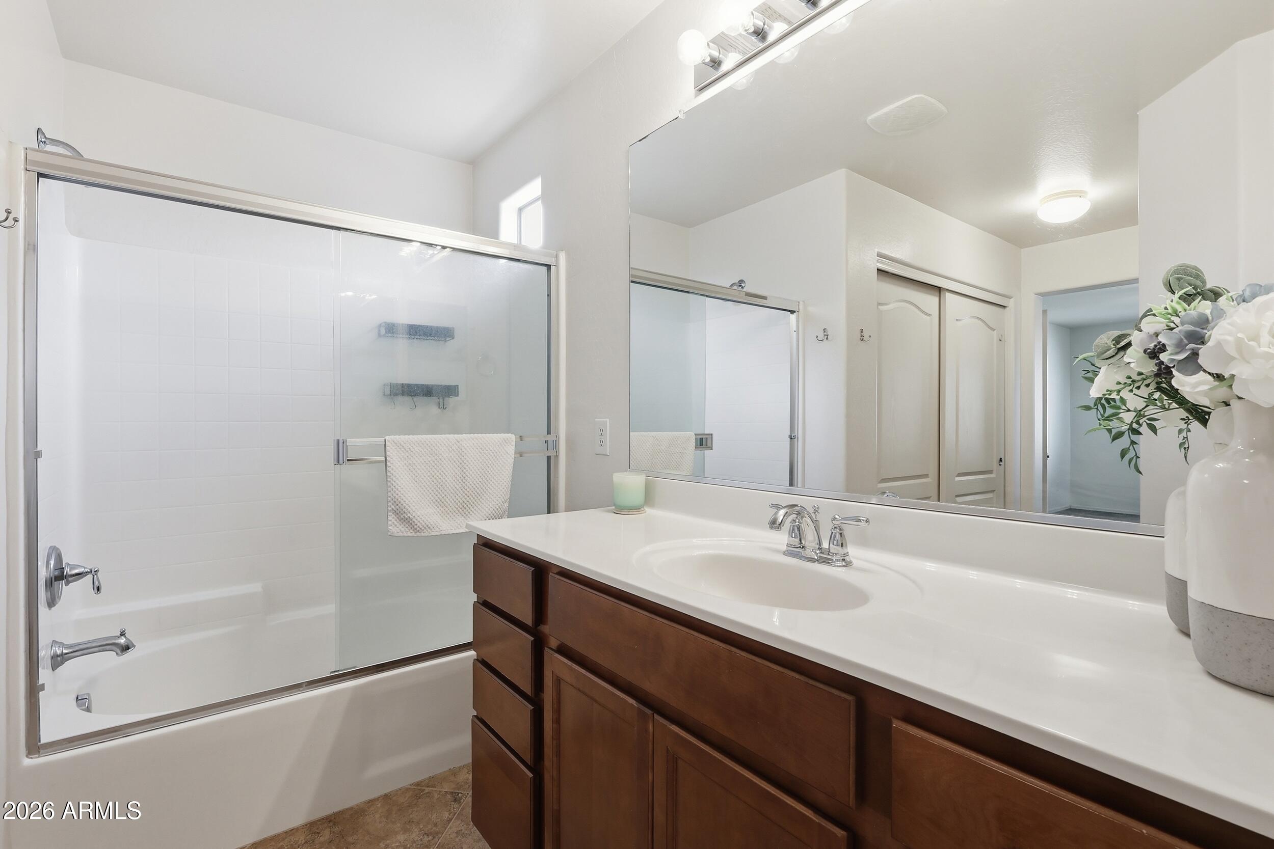 1853 South Balboa Drive Gilbert, AZ 85295 - Photo 21 of 32 a bathroom with a sink a mirror and a shower