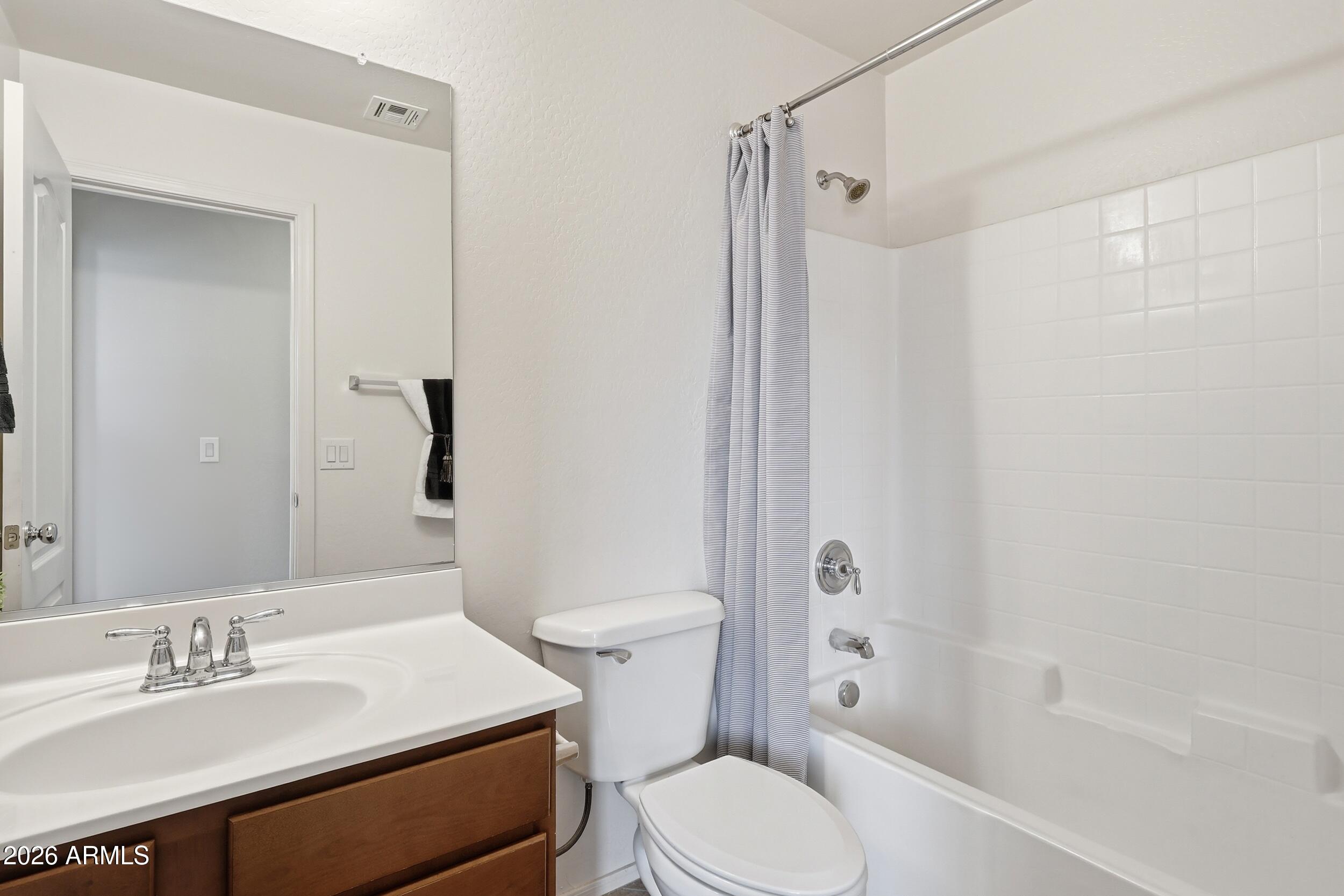 1853 South Balboa Drive Gilbert, AZ 85295 - Photo 24 of 32 a bathroom with a sink toilet vanity and shower