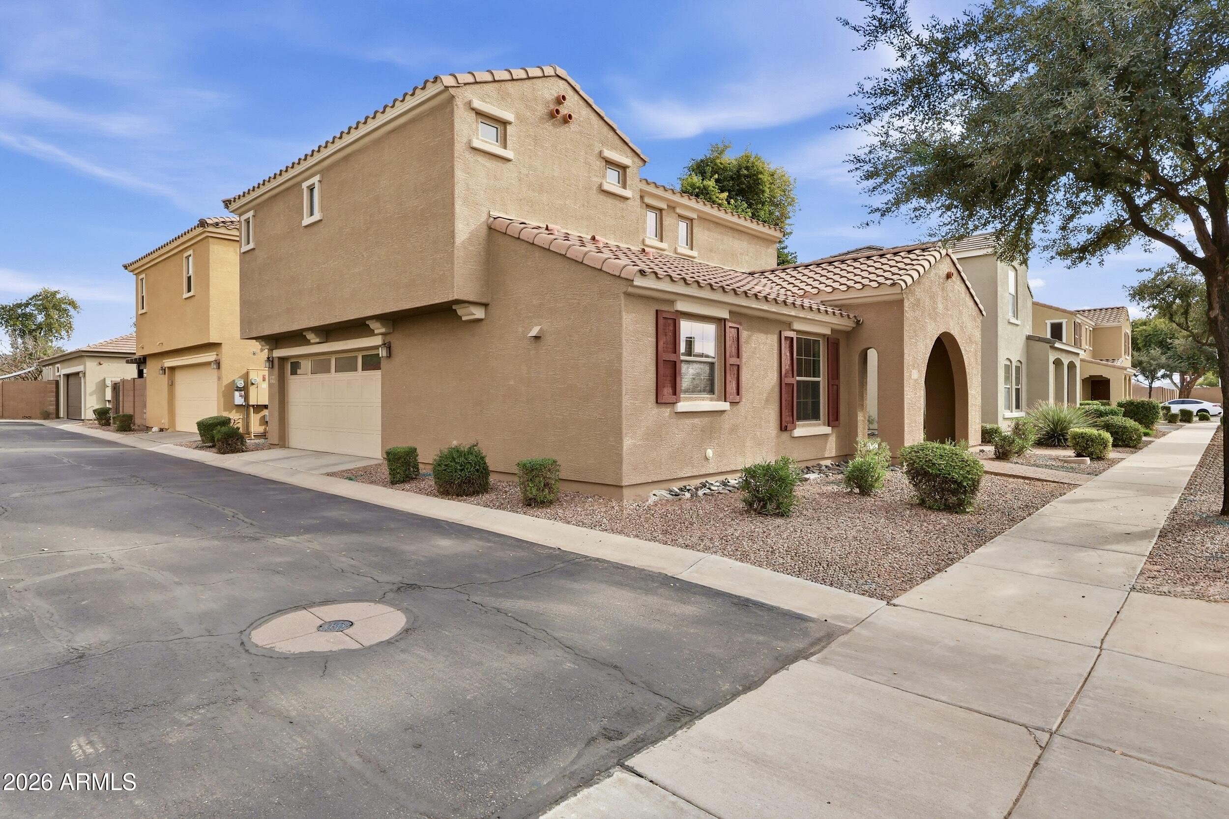 1853 South Balboa Drive Gilbert, AZ 85295 - Photo 31 of 32 a front view of a house with yard and parking