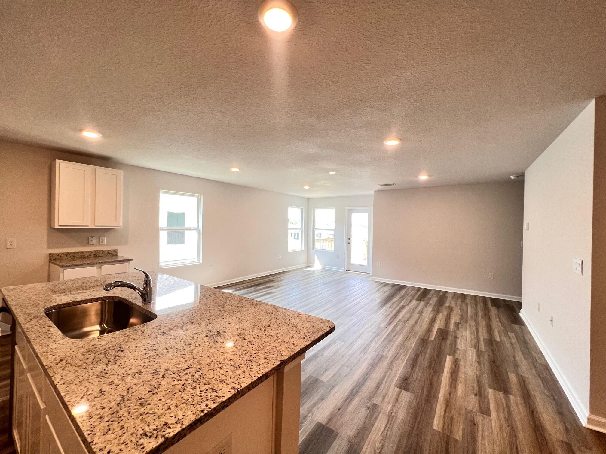 2652 Saltgrass Way Crestview, FL 32536 - Photo 5 of 18 a kitchen with a sink and a refrigerator