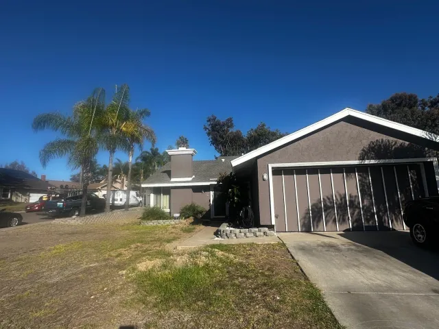 a view of a house with a yard and garage
