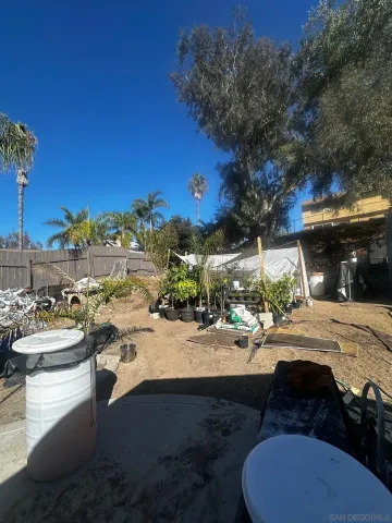 a view of a patio with a table and chairs under an umbrella