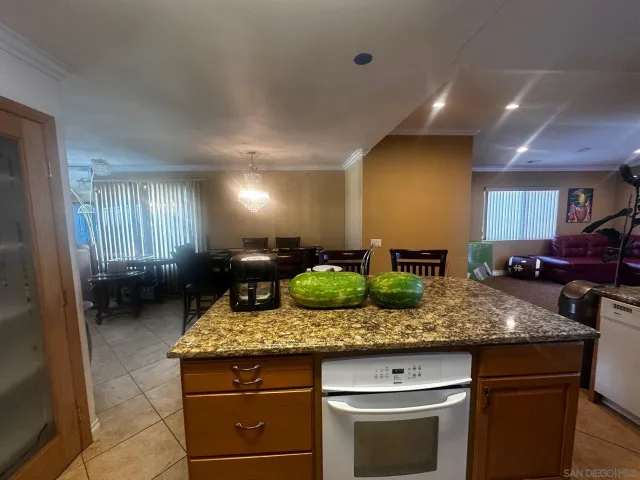 a view of living room with granite countertop furniture and window