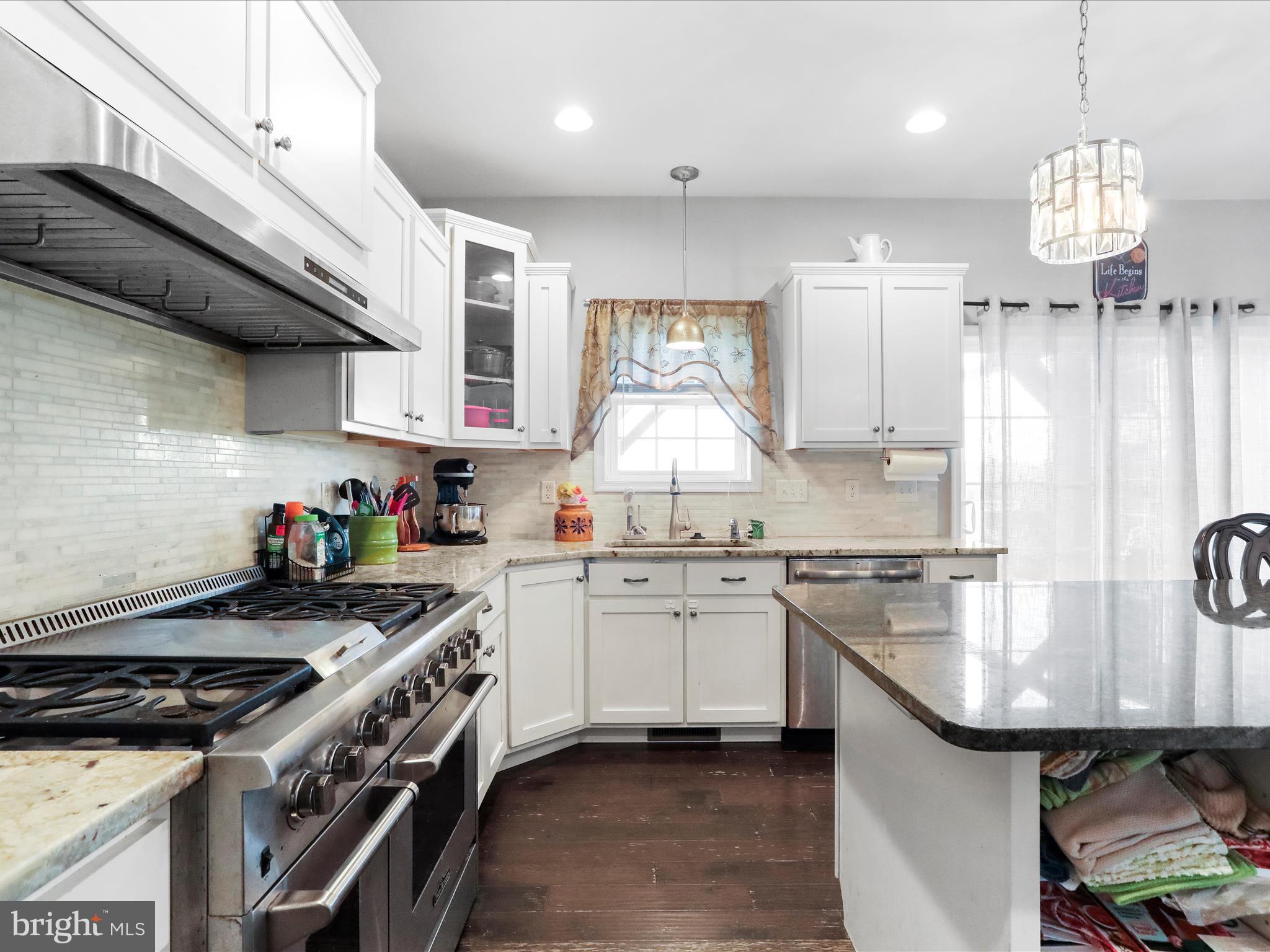 1699 Wind Flower Road, Unit 59 Chambersburg, PA 17202 - Photo 15 of 27 a kitchen with stainless steel appliances granite countertop a sink a stove and a wooden floors