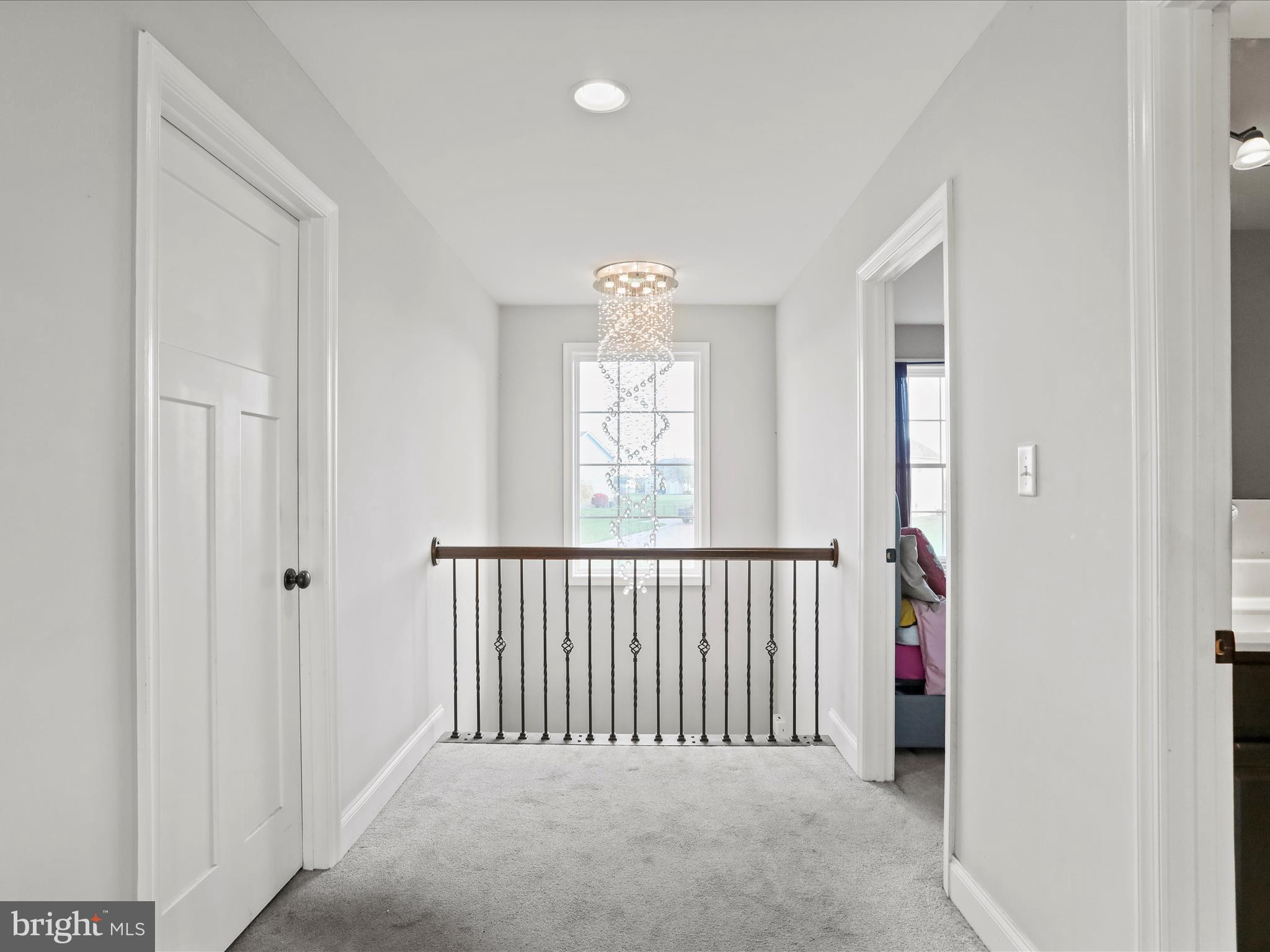 1699 Wind Flower Road, Unit 59 Chambersburg, PA 17202 - Photo 18 of 27 a view of a hallway with windows