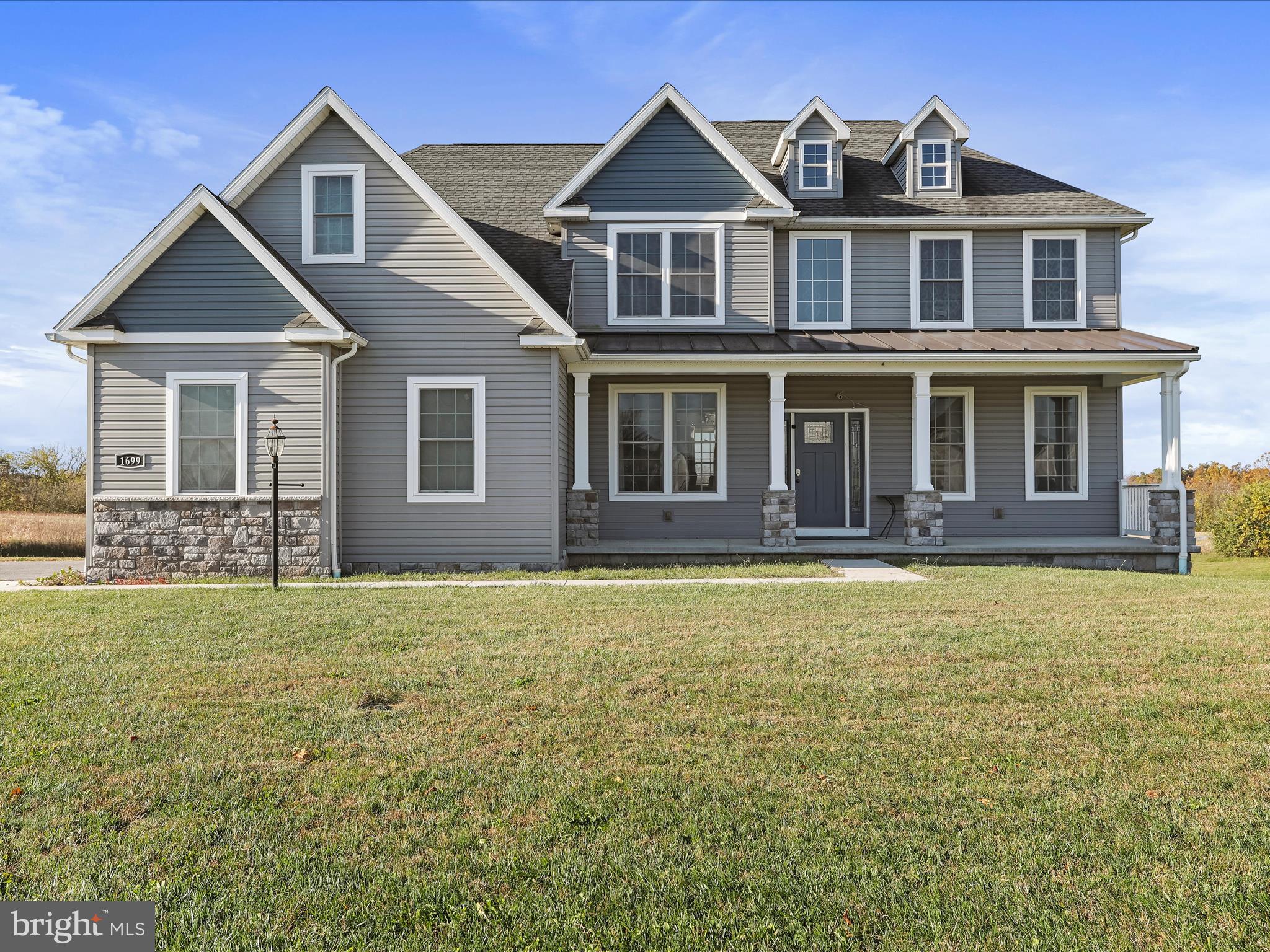 1699 Wind Flower Road, Unit 59 Chambersburg, PA 17202 - Photo 4 of 27 a front view of a house with garden