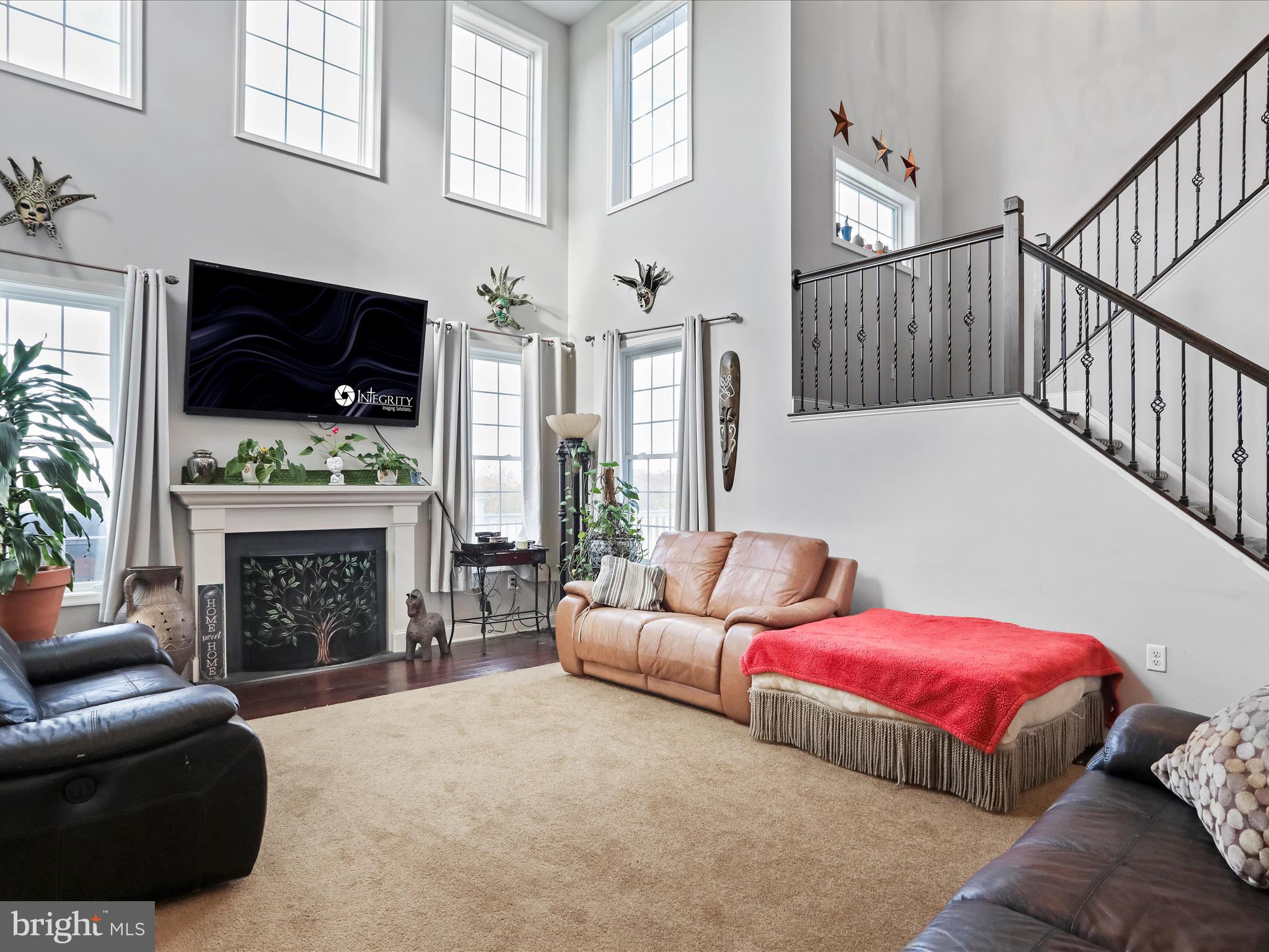 1699 Wind Flower Road, Unit 59 Chambersburg, PA 17202 - Photo 10 of 27 a living room with furniture a flat screen tv and a fireplace