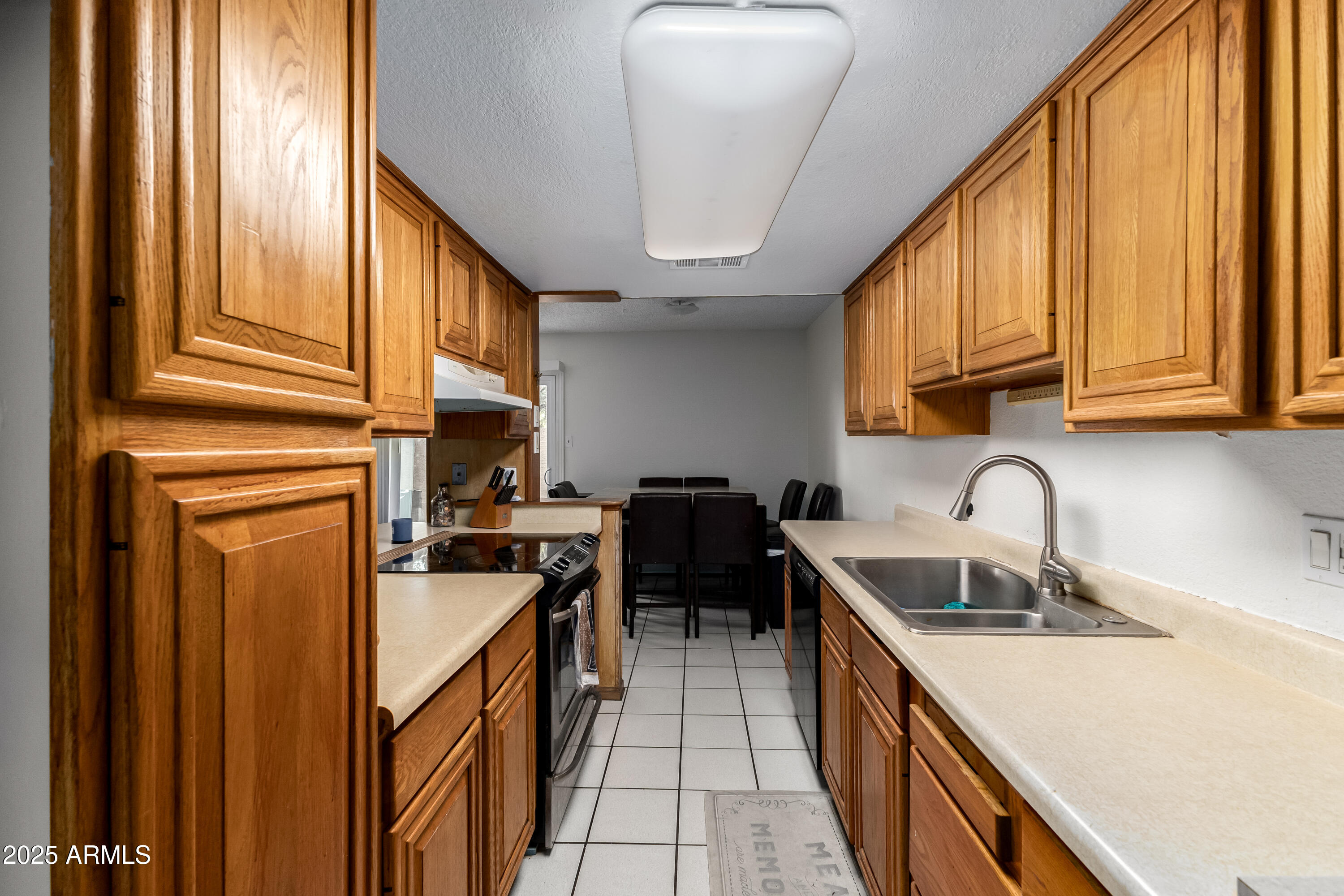 4107 West Wonderview Road Phoenix, AZ 85019 - Photo 6 of 13 a kitchen with stainless steel appliances granite countertop a sink a stove and a refrigerator