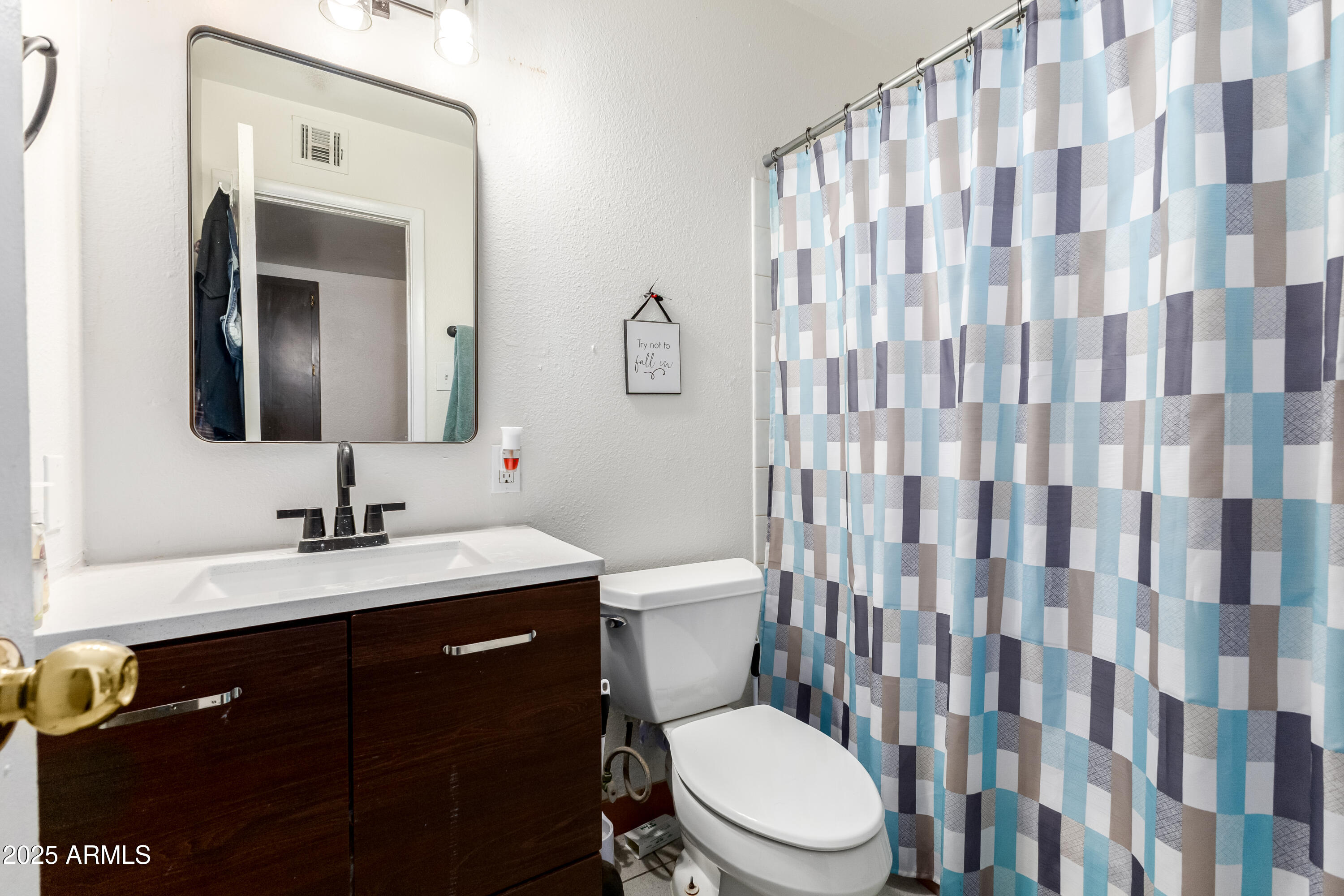 4107 West Wonderview Road Phoenix, AZ 85019 - Photo 8 of 13 a bathroom with a granite countertop sink a toilet and a mirror