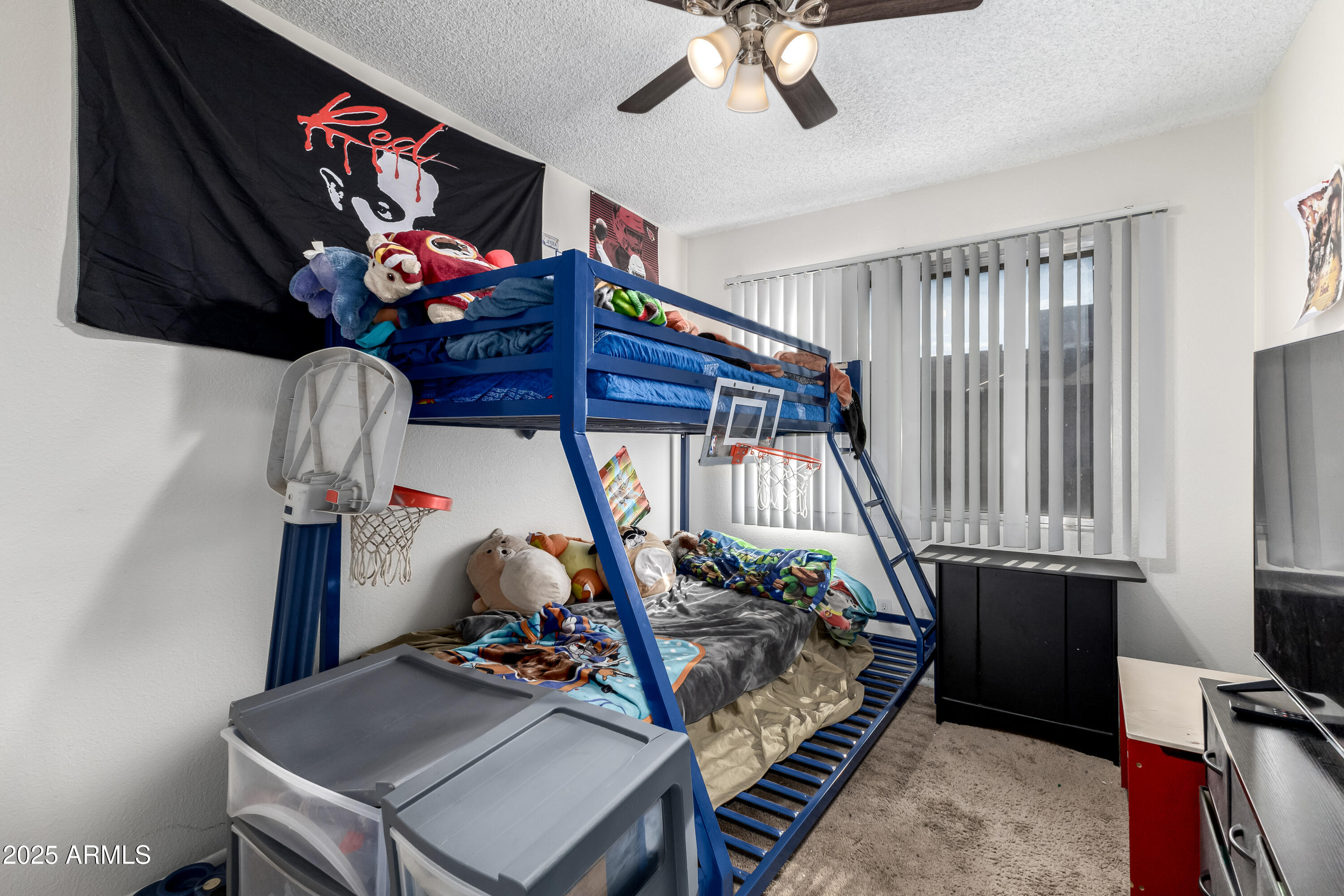 4107 West Wonderview Road Phoenix, AZ 85019 - Photo 9 of 13 a bedroom with bed and a chandelier