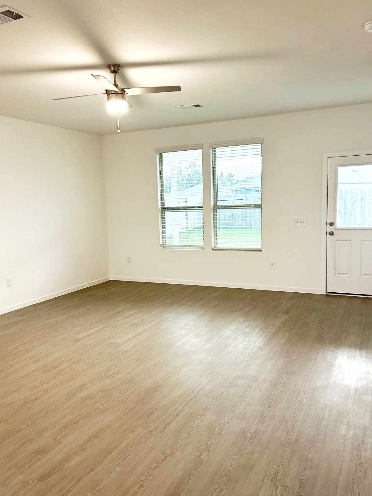 14973 Rustic Moon Road Conroe, TX 77302 - Photo 7 of 22 an empty room with a empty space and windows