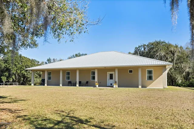 a view of house with outdoor space and garden
