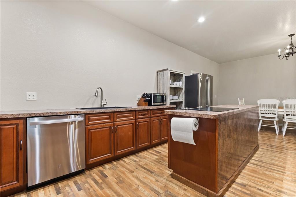 3865 Rabbit Run Road Wauchula, FL 33873 - Photo 11 of 43 a living room with stainless steel appliances granite countertop a sink and wooden cabinets with wooden floor