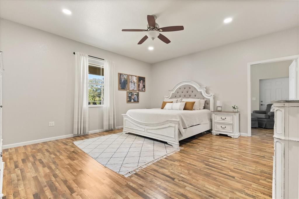 3865 Rabbit Run Road Wauchula, FL 33873 - Photo 13 of 43 a bedroom with a large bed and a chandelier