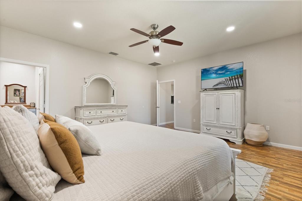 3865 Rabbit Run Road Wauchula, FL 33873 - Photo 14 of 43 a bedroom with a large bed and a chandelier