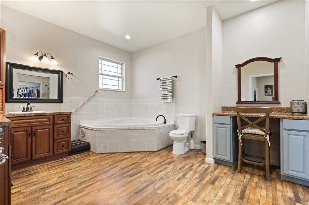 3865 Rabbit Run Road Wauchula, FL 33873 - Photo 16 of 43 a spacious bathroom with a tub sink toilet and mirror