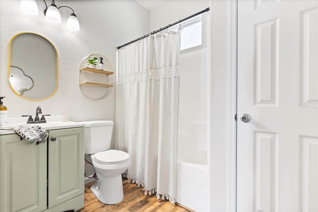 3865 Rabbit Run Road Wauchula, FL 33873 - Photo 24 of 43 a bathroom with a toilet a sink and a mirror