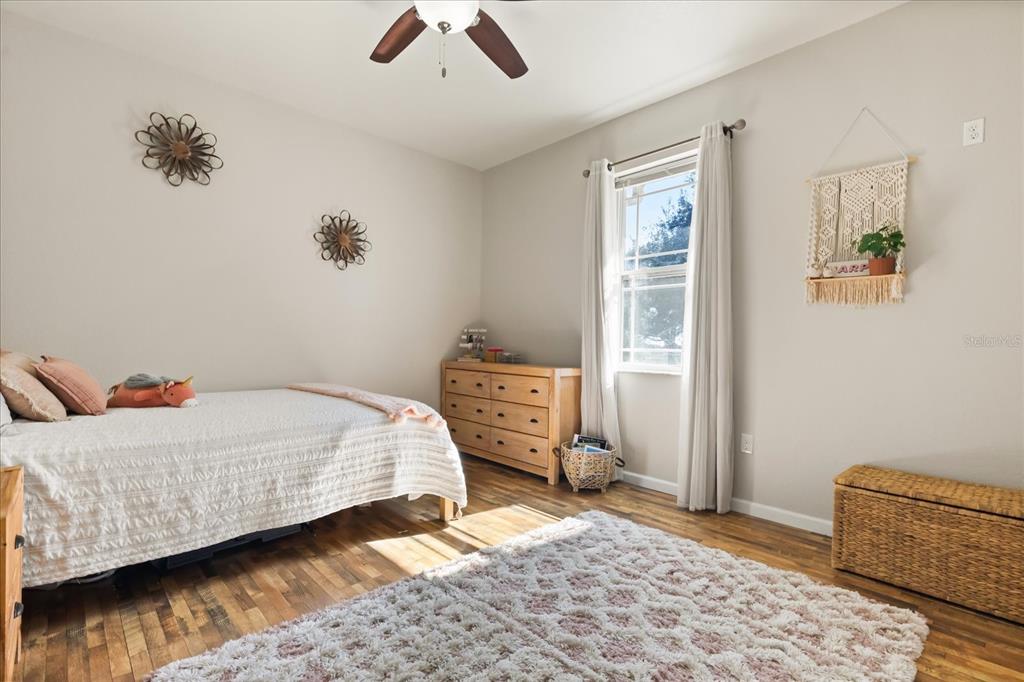 3865 Rabbit Run Road Wauchula, FL 33873 - Photo 25 of 43 a bedroom with a bed and wooden floor