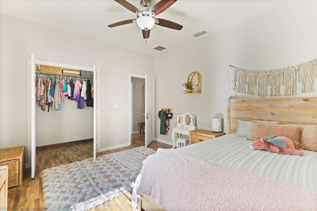 3865 Rabbit Run Road Wauchula, FL 33873 - Photo 26 of 43 a bedroom with a large bed and a chandelier