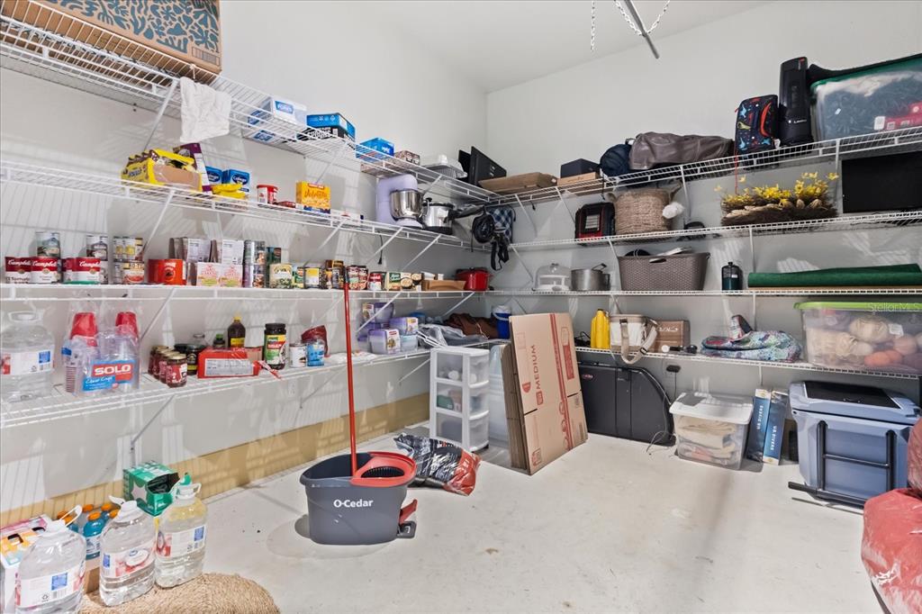 3865 Rabbit Run Road Wauchula, FL 33873 - Photo 27 of 43 a storage room with lots of clutter and refrigerator