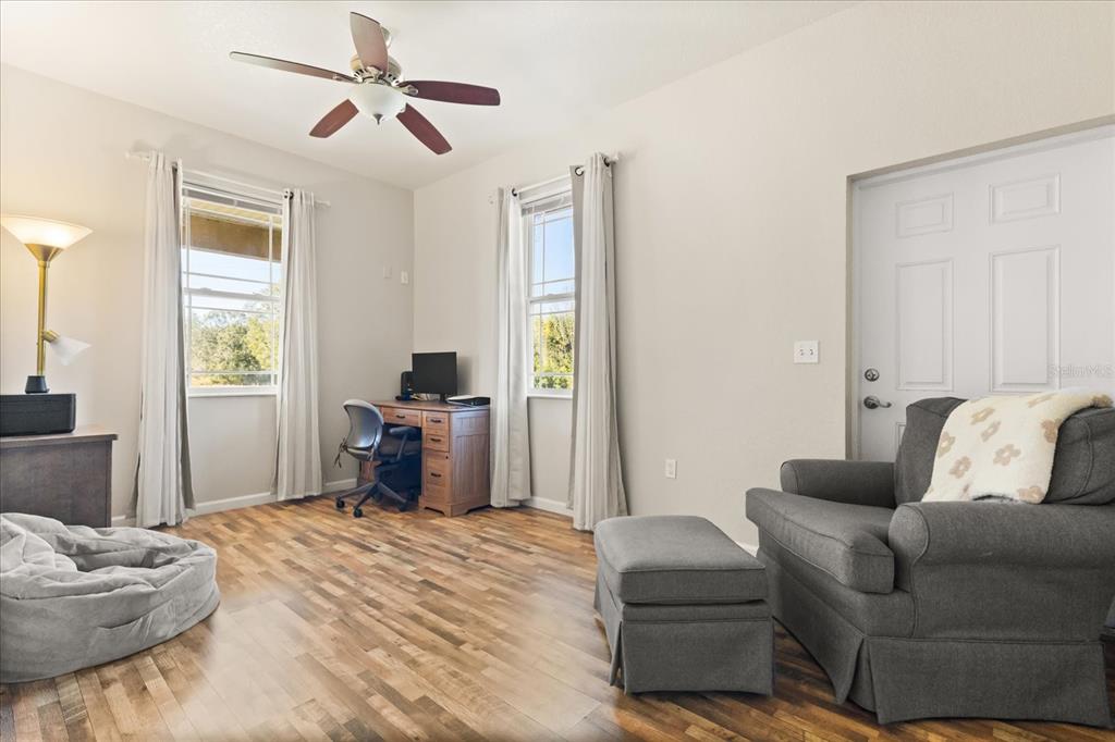 3865 Rabbit Run Road Wauchula, FL 33873 - Photo 5 of 43 a bedroom with a bed and wooden floor