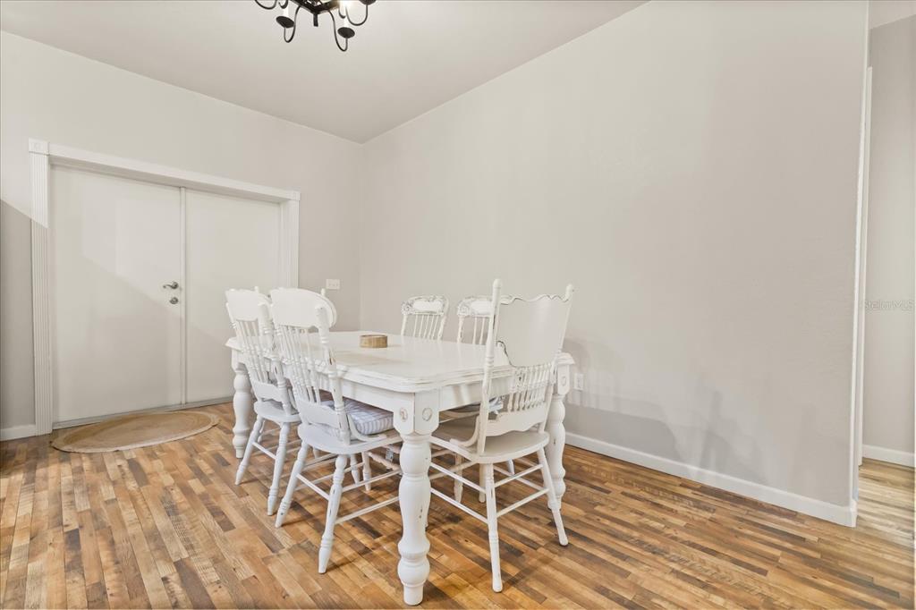 3865 Rabbit Run Road Wauchula, FL 33873 - Photo 8 of 43 a view of a dining room with furniture and wooden floor