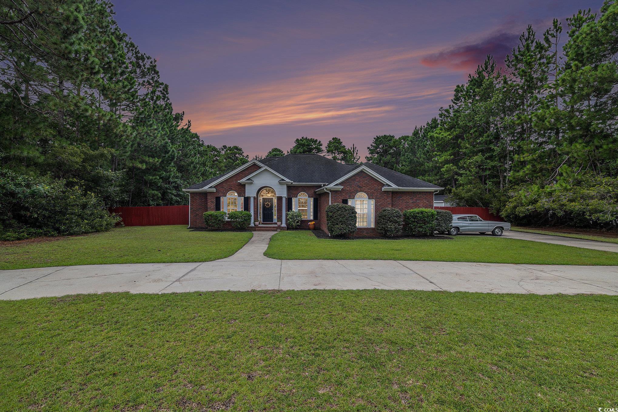 Single story home with brick siding and concrete driveway
