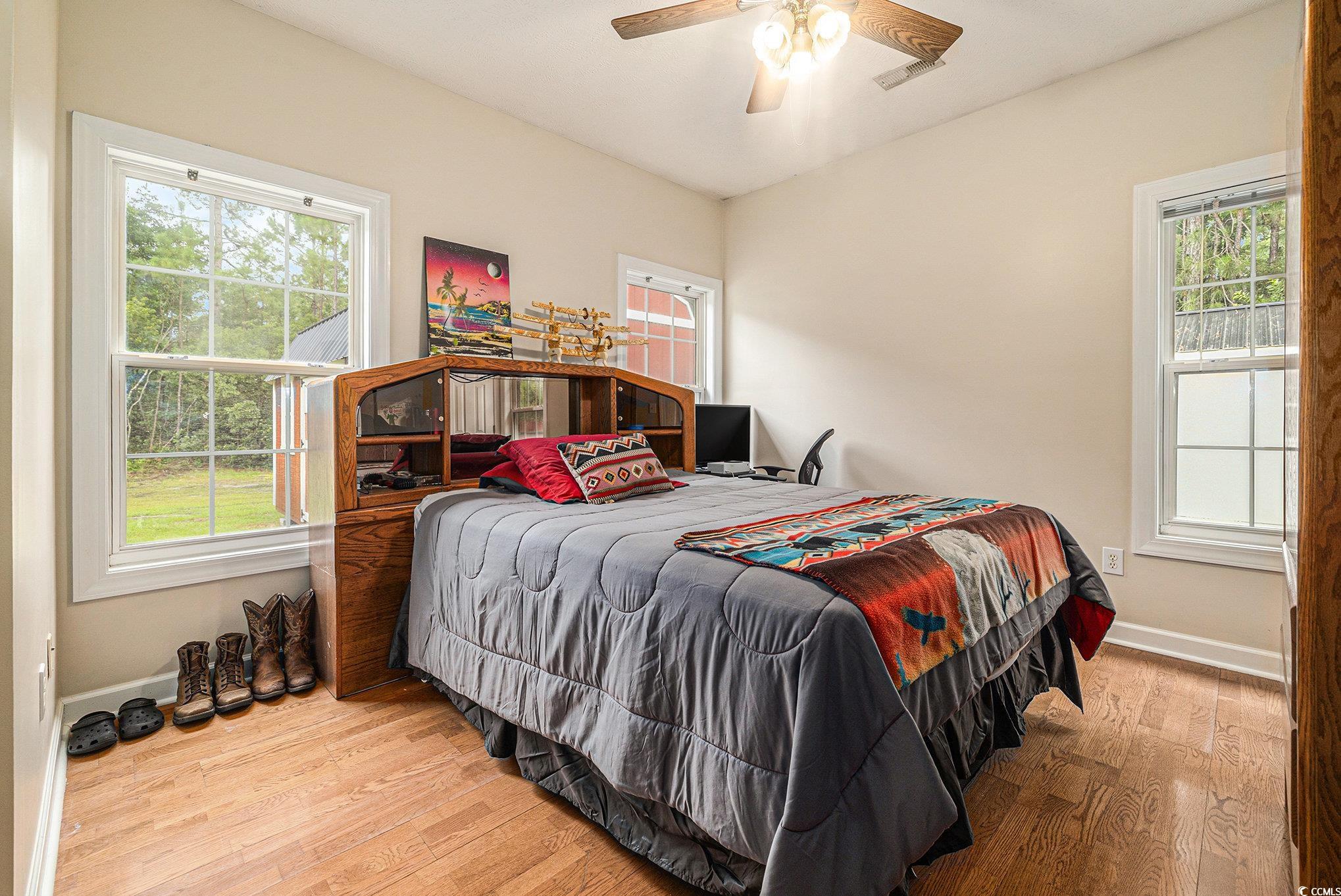 2425 Hunters Trail Myrtle Beach, SC 29588 - Photo 24 of 40 Bedroom with wood finished floors, multiple windows, and ceiling fan