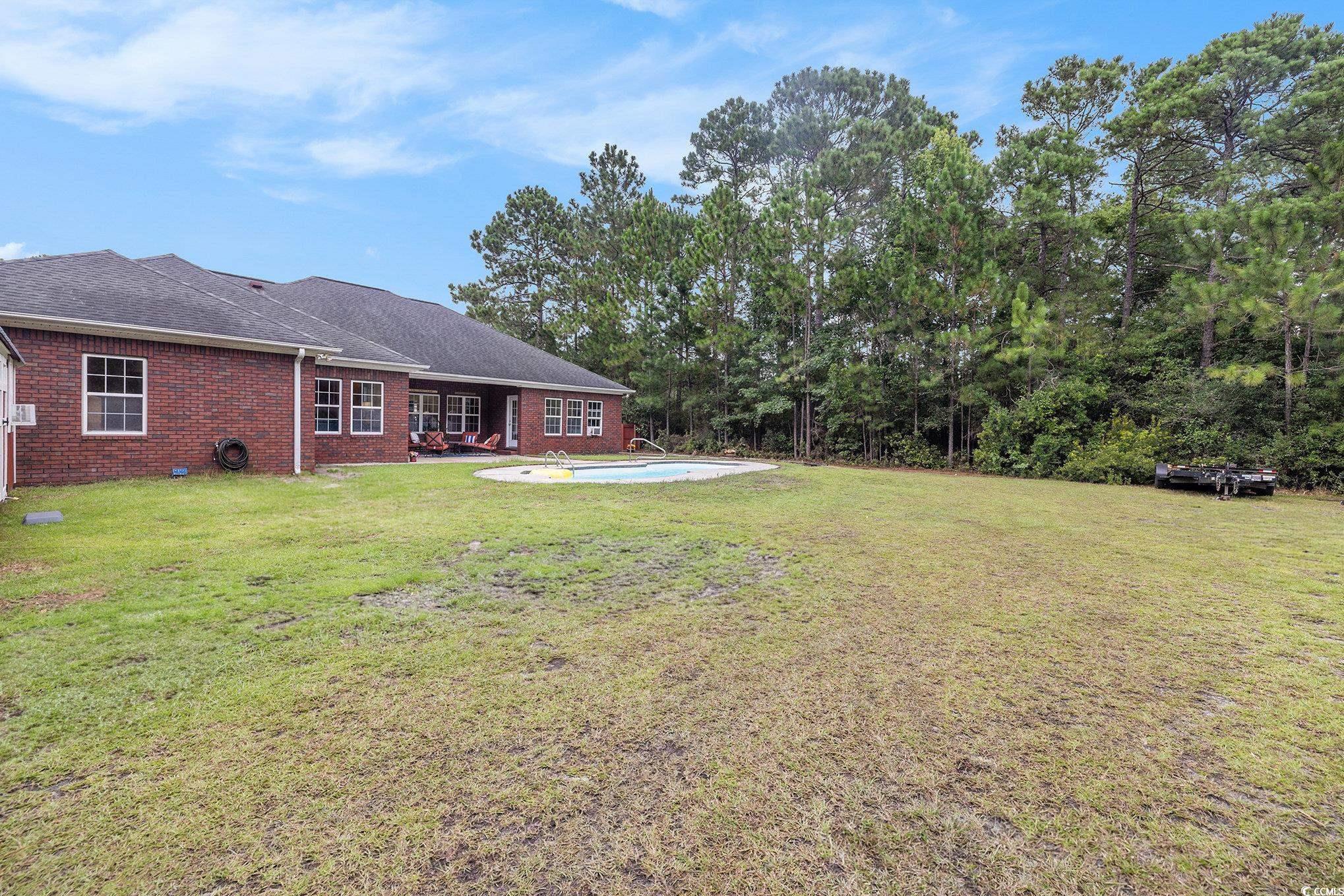 2425 Hunters Trail Myrtle Beach, SC 29588 - Photo 32 of 40 View of green lawn with an outdoor pool