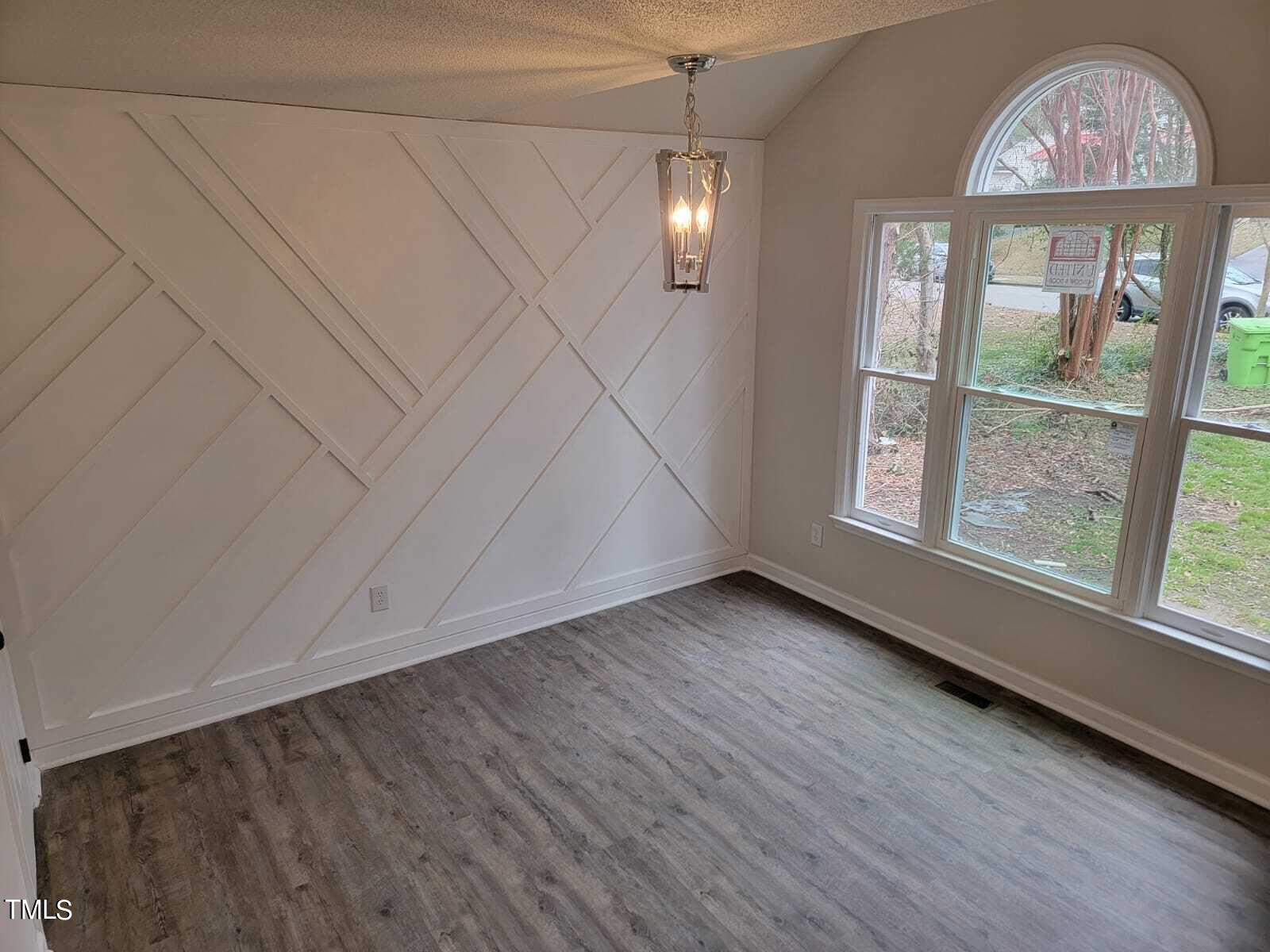 4008 Old Coach Road Raleigh, NC 27616 - Photo 17 of 48 an empty room with wooden floor fan and windows