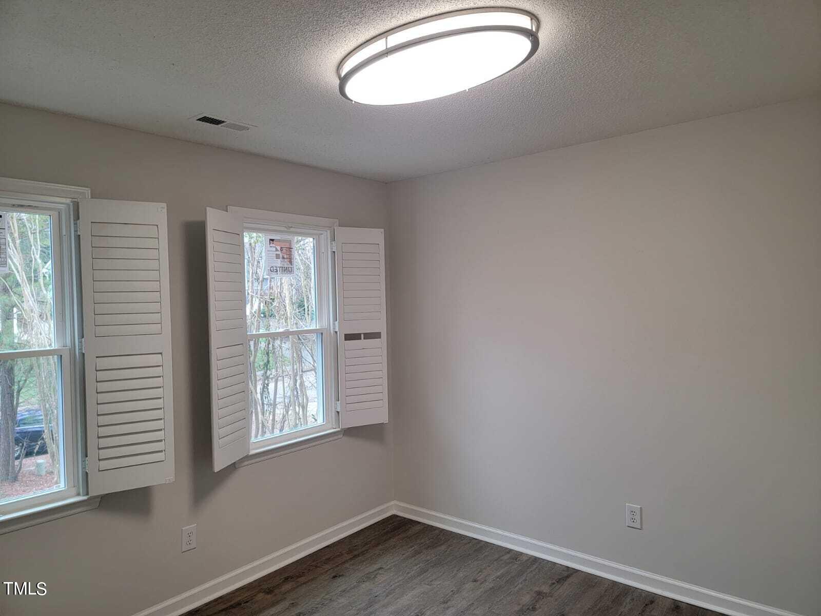4008 Old Coach Road Raleigh, NC 27616 - Photo 35 of 48 an empty room with wooden floor and windows