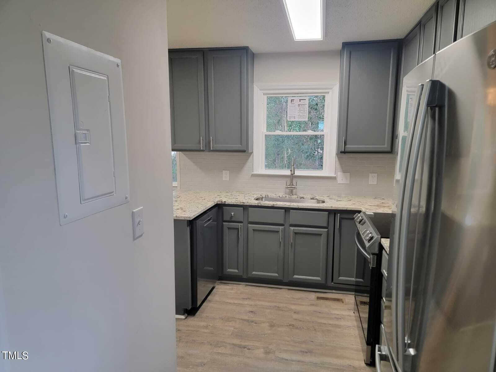 4008 Old Coach Road Raleigh, NC 27616 - Photo 5 of 48 a kitchen with stainless steel appliances granite countertop a refrigerator and a sink