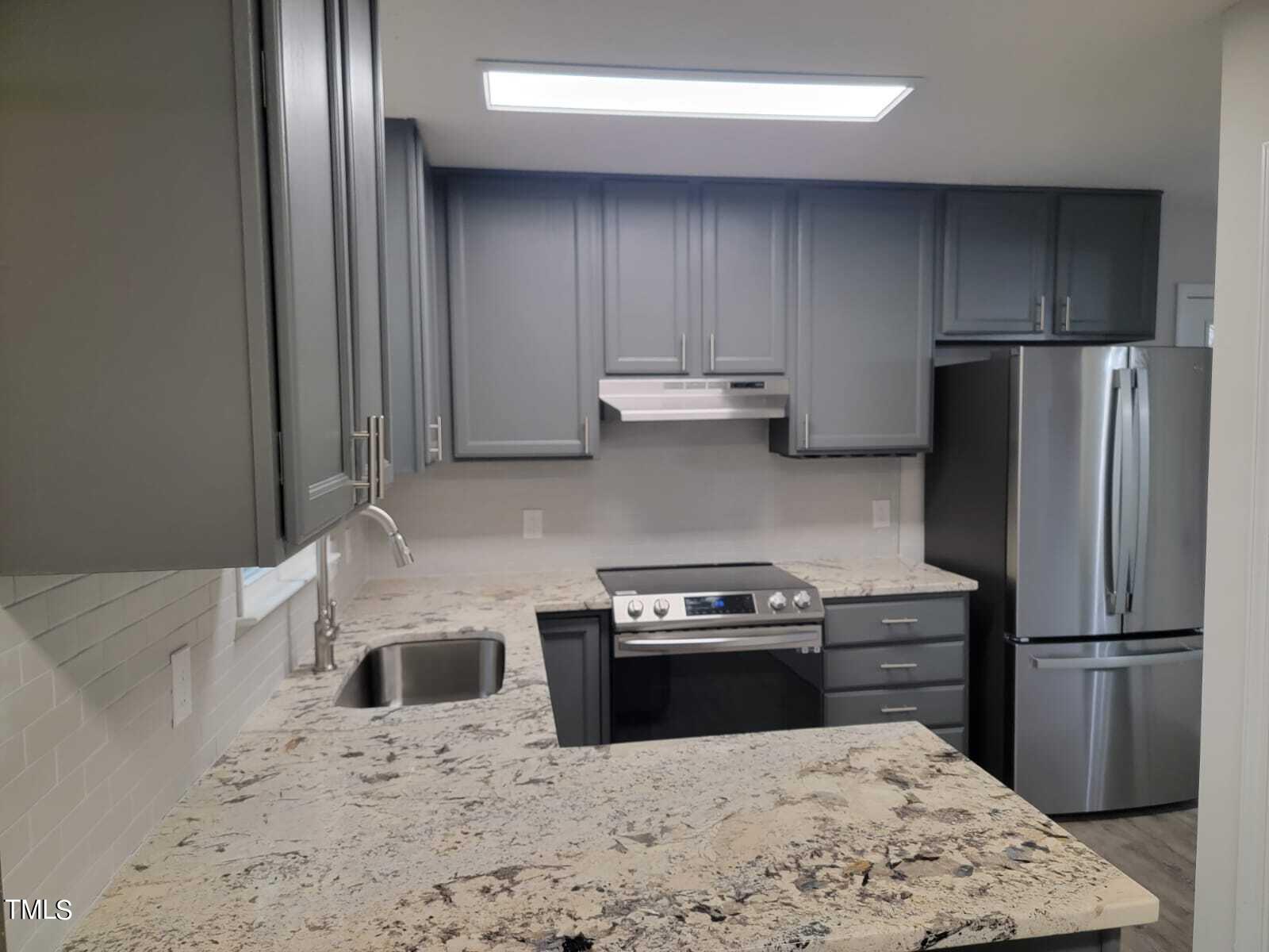 4008 Old Coach Road Raleigh, NC 27616 - Photo 8 of 48 a kitchen with a stove a refrigerator and a sink