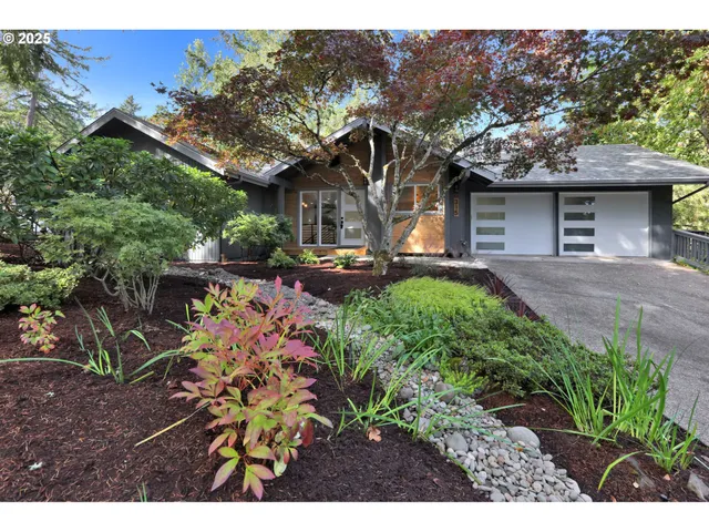 a front view of a house with a garden