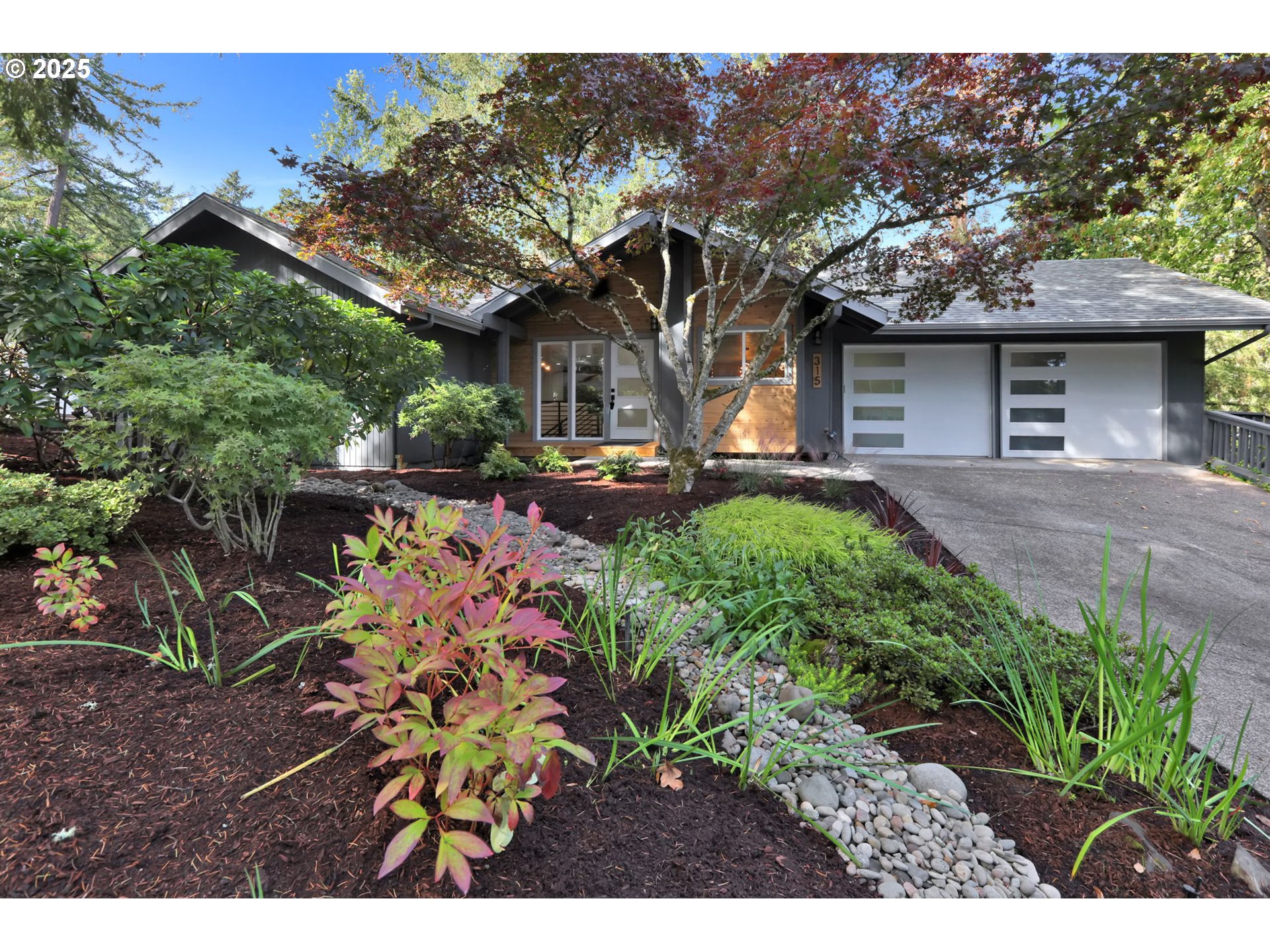 315 Brookside Drive Eugene, OR 97405 - Photo 1 of 46 a front view of a house with a garden