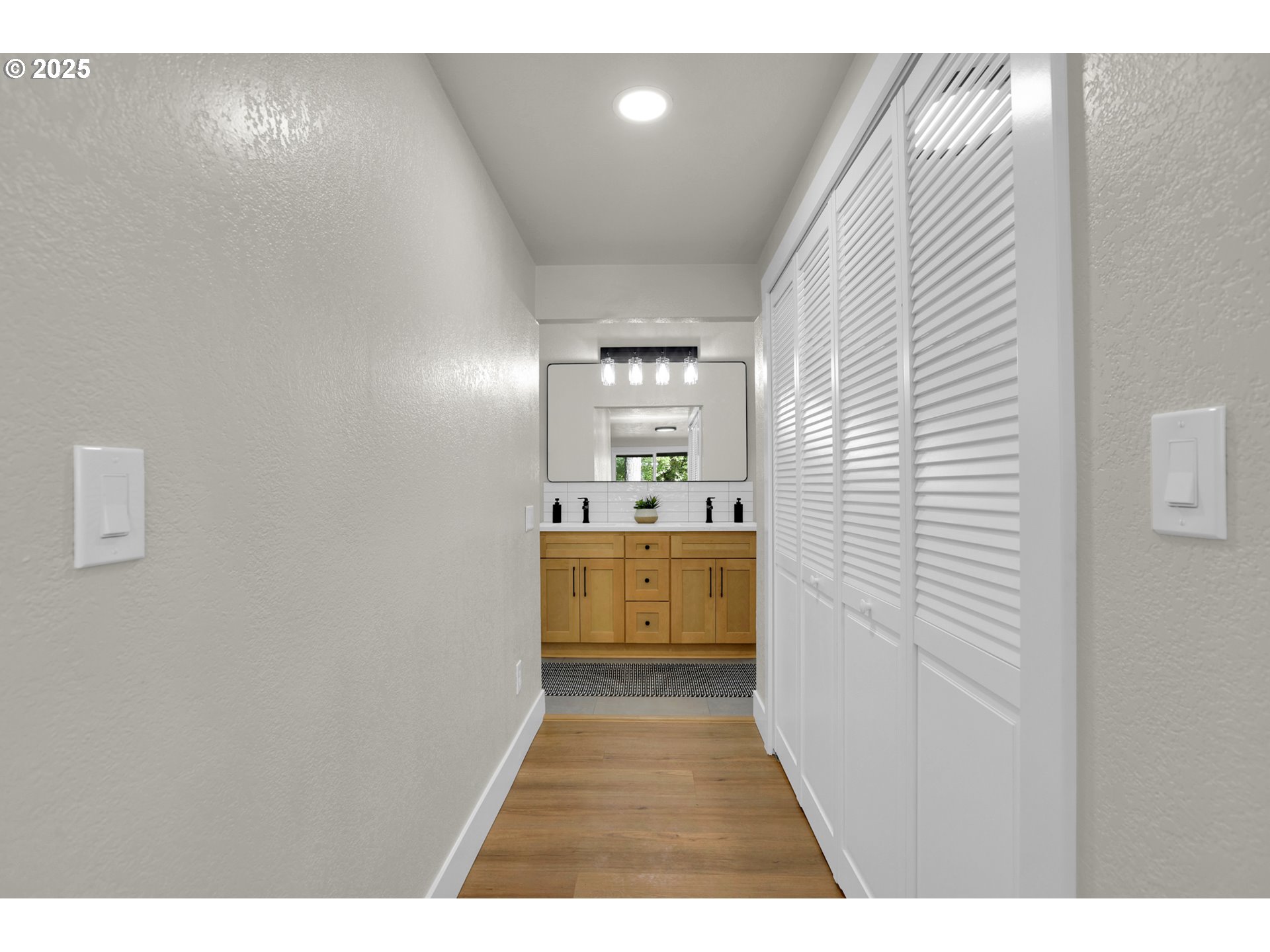 315 Brookside Drive Eugene, OR 97405 - Photo 20 of 46 a view of a hallway with a white kitchen