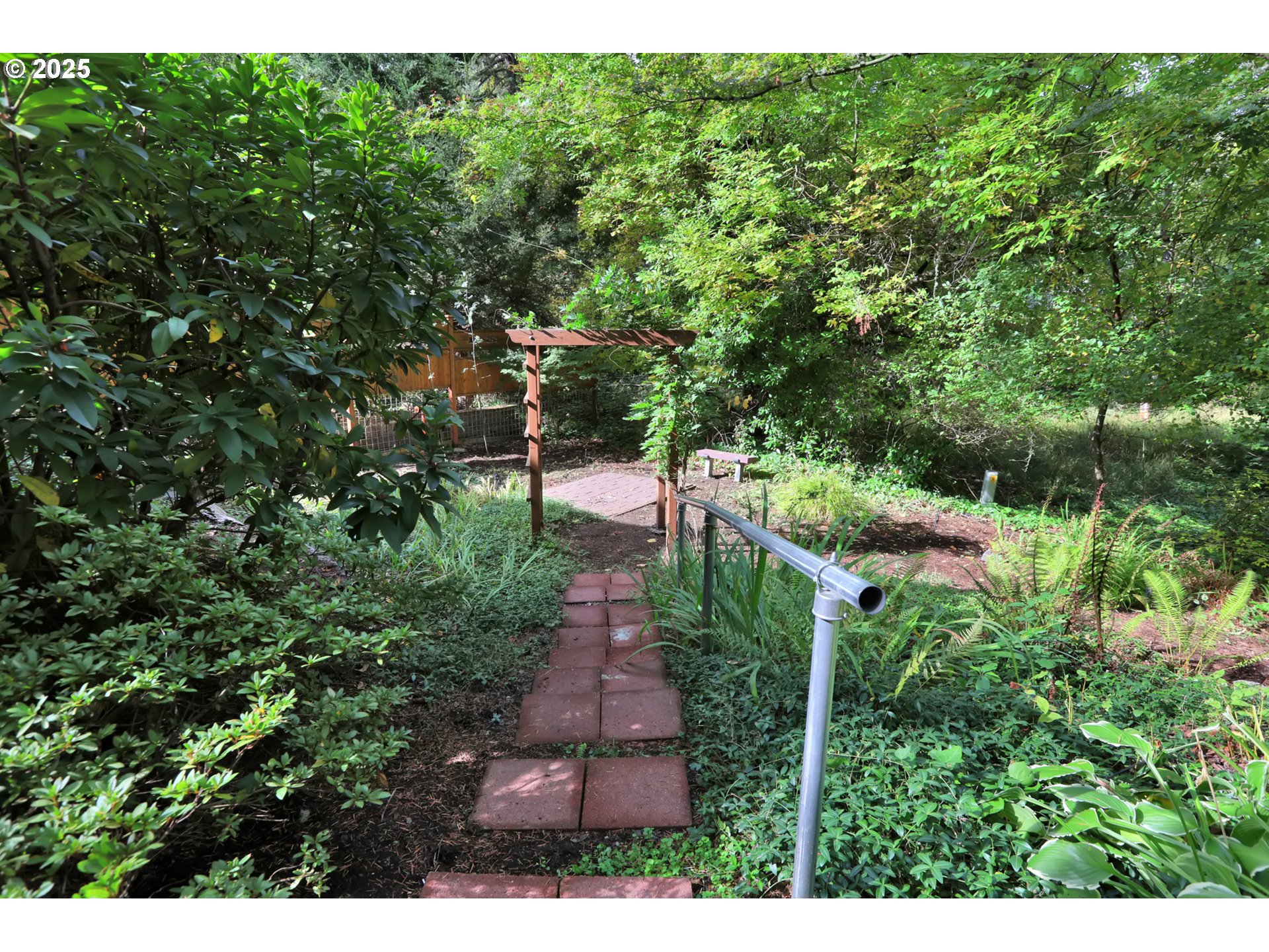 315 Brookside Drive Eugene, OR 97405 - Photo 44 of 46 a view of a garden with plants and large trees