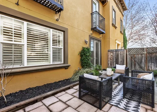 a view of a patio with couches and potted plants