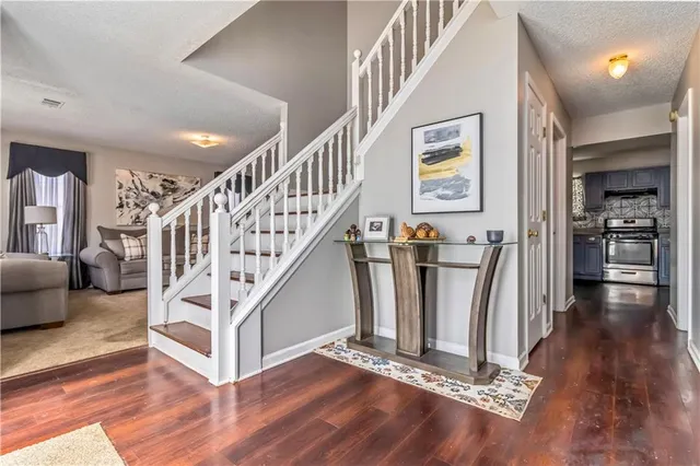 a view of entryway with livingroom and stairs