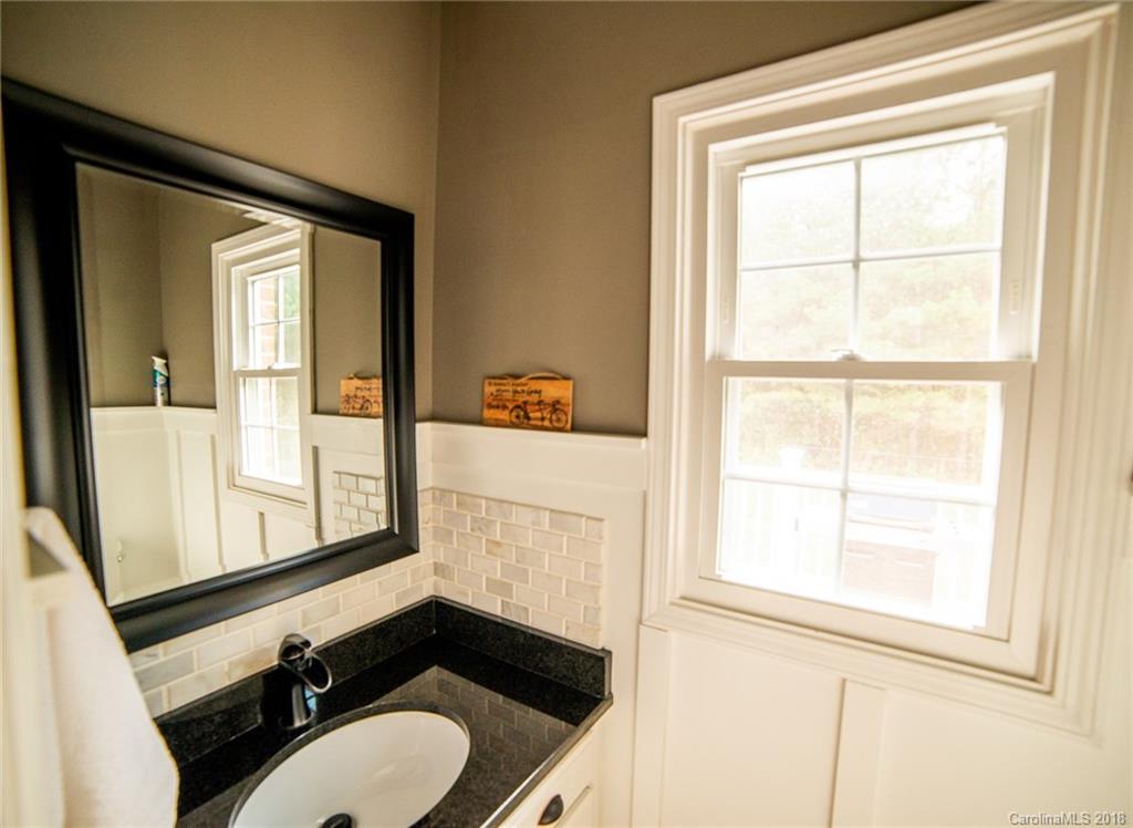 4225 Rowell Road Lancaster, SC 29720 - Photo 12 of 34 a bathroom with a sink a toilet and a mirror