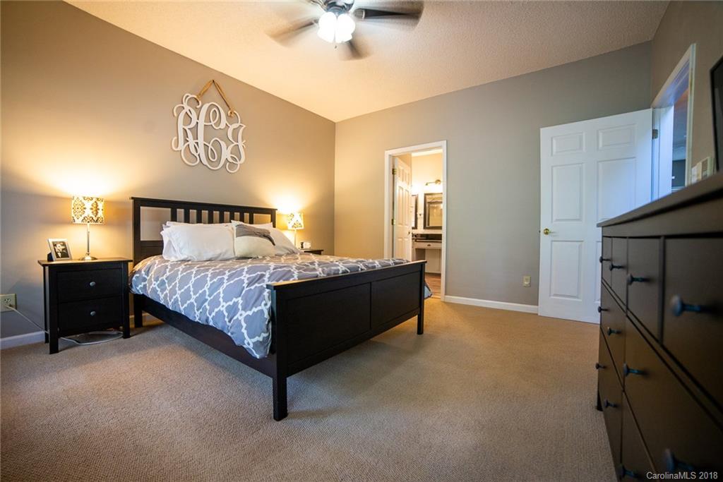 4225 Rowell Road Lancaster, SC 29720 - Photo 17 of 34 a bedroom with a bed and a chandelier
