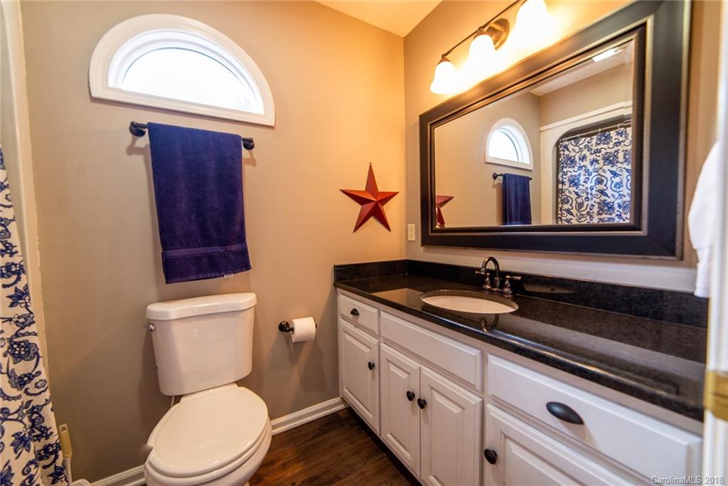 4225 Rowell Road Lancaster, SC 29720 - Photo 24 of 34 a bathroom with a toilet a sink and mirror