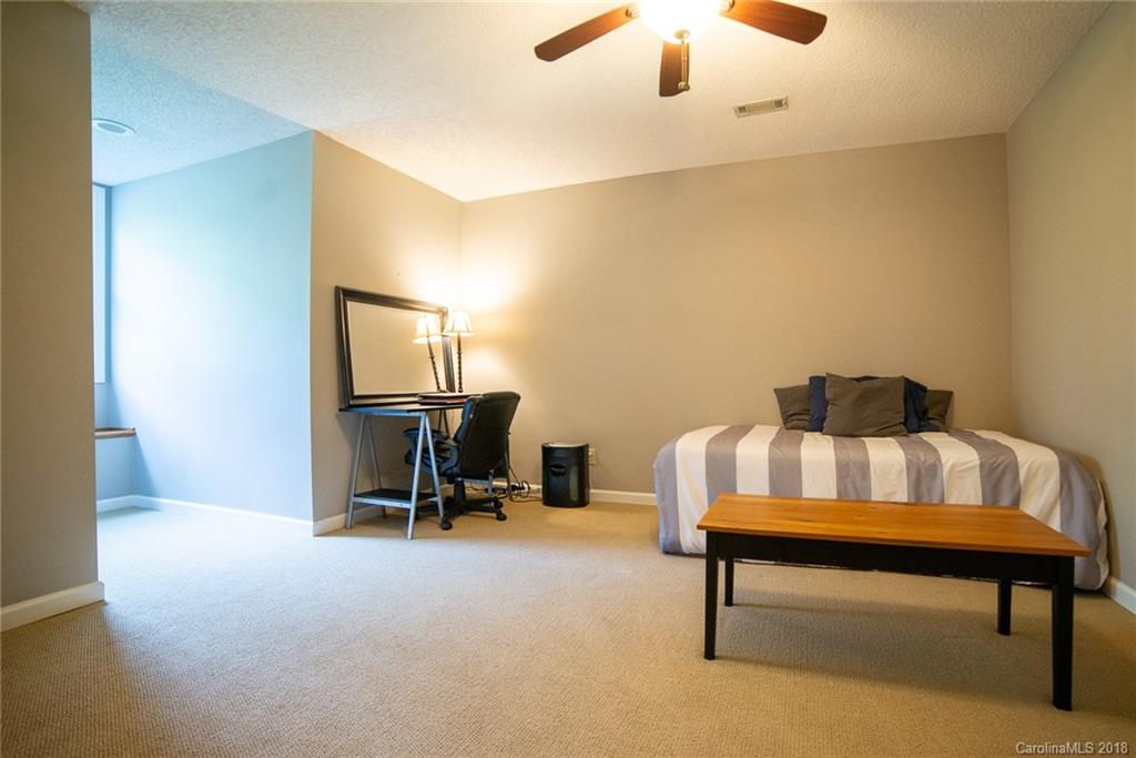 4225 Rowell Road Lancaster, SC 29720 - Photo 26 of 34 a bedroom with a bed and a chandelier