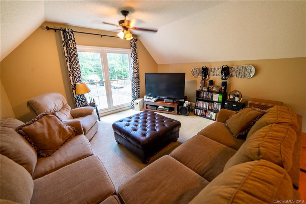 4225 Rowell Road Lancaster, SC 29720 - Photo 27 of 34 a living room with furniture a flat screen tv and a window