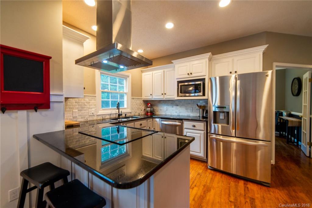 4225 Rowell Road Lancaster, SC 29720 - Photo 6 of 34 a kitchen with stainless steel appliances granite countertop a sink refrigerator and microwave